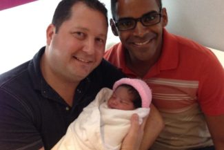 Co-founders of MIRACLE Surrogacy, Brian and Henry Yaden, with their daughter Patricia who was born through surrogacy.